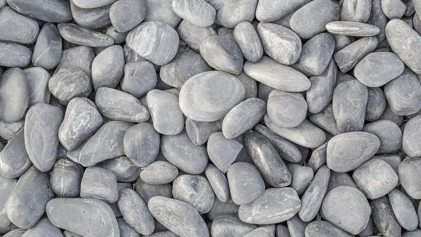 Beach pebbles piled at the Olimar Stone yard in Miami